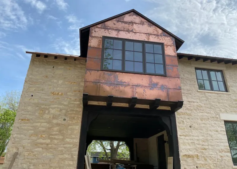 Copper metal panel facade on a stone building for Roof Repair in Rexburg